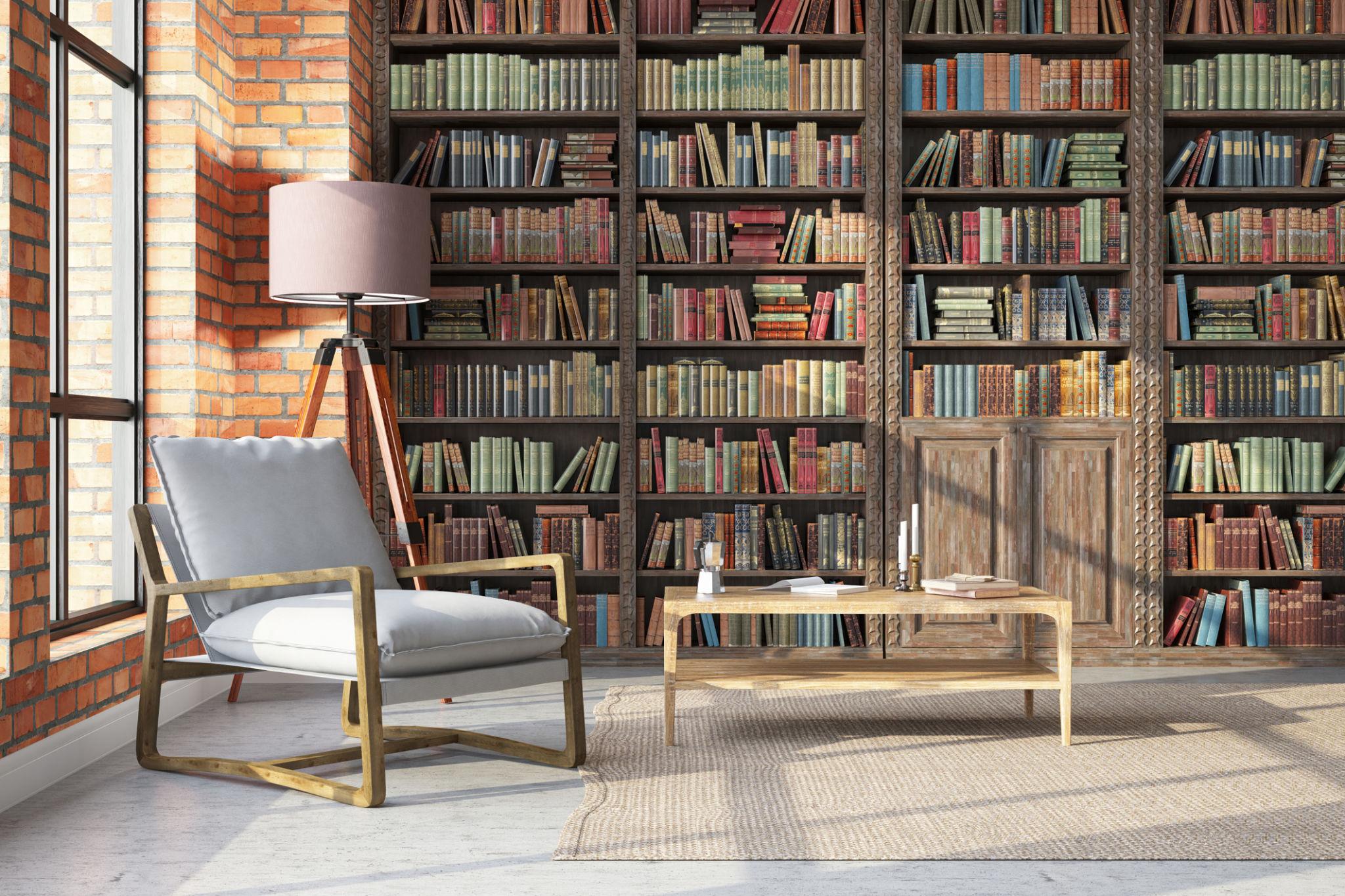 A cozy reading corner with bookshelves and café chairs.